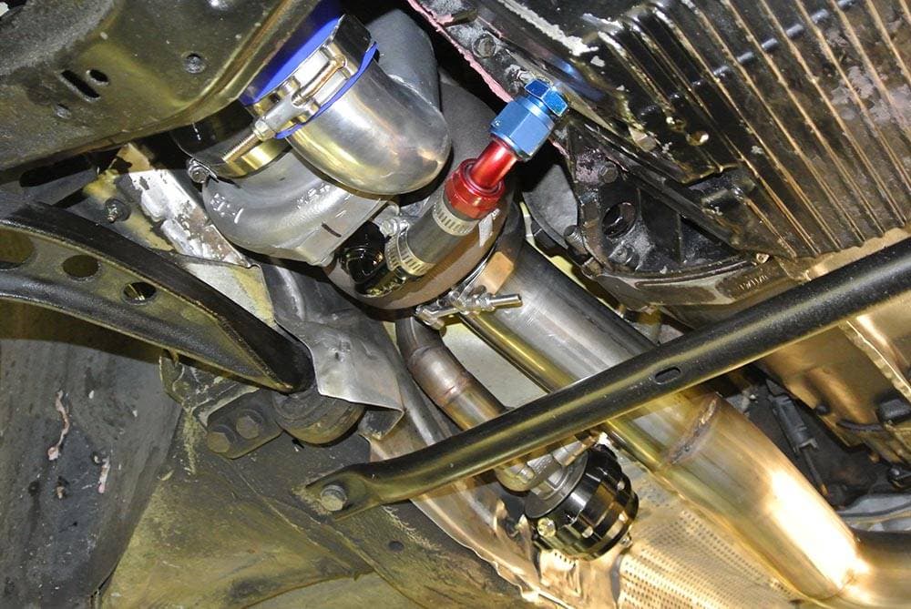 Custom turbo system with stainless piping under a BMW at Turbo Lab in Orem