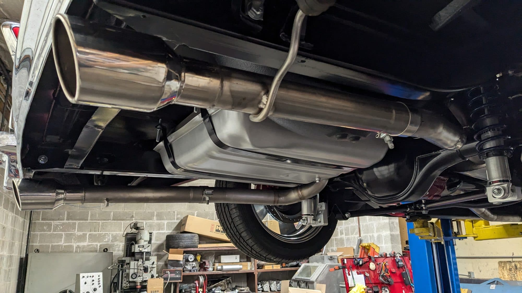 New exhaust and tip under a car on the lift at Turbo Lab in Orem, UT