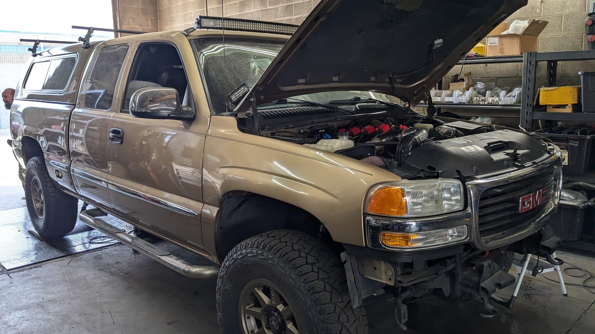 GMC Yukon with the hood open for engine work at Turbo Lab in Orem, UT