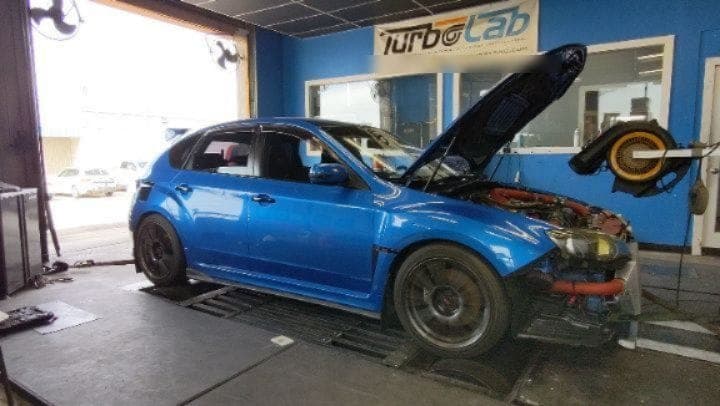 Blue Subaru WRX on the dyno at Turbo Lab after a skipped-timing repair and flex fuel tune