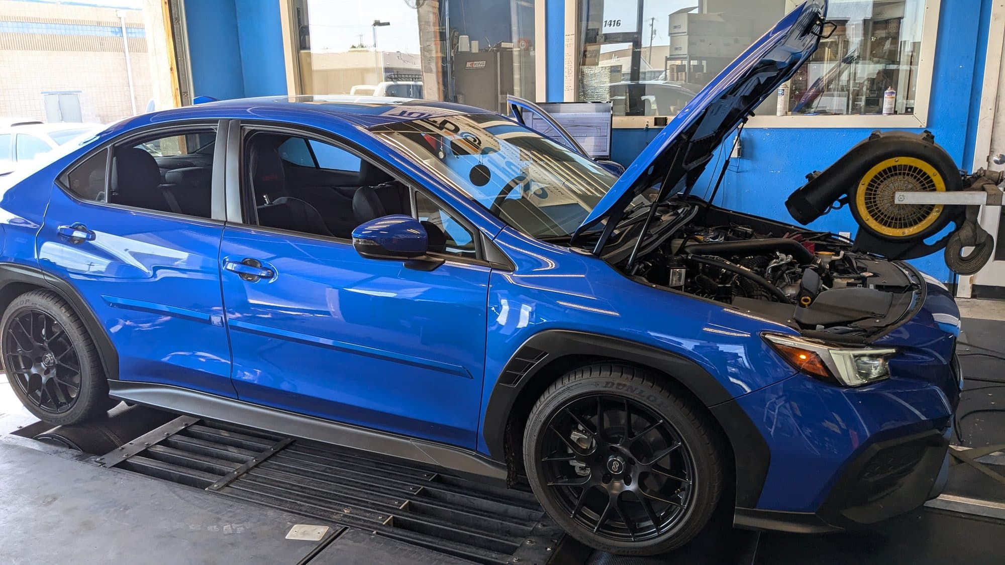 Blue Subaru WRX on the dyno with the hood up at Turbo Lab in Orem, UT