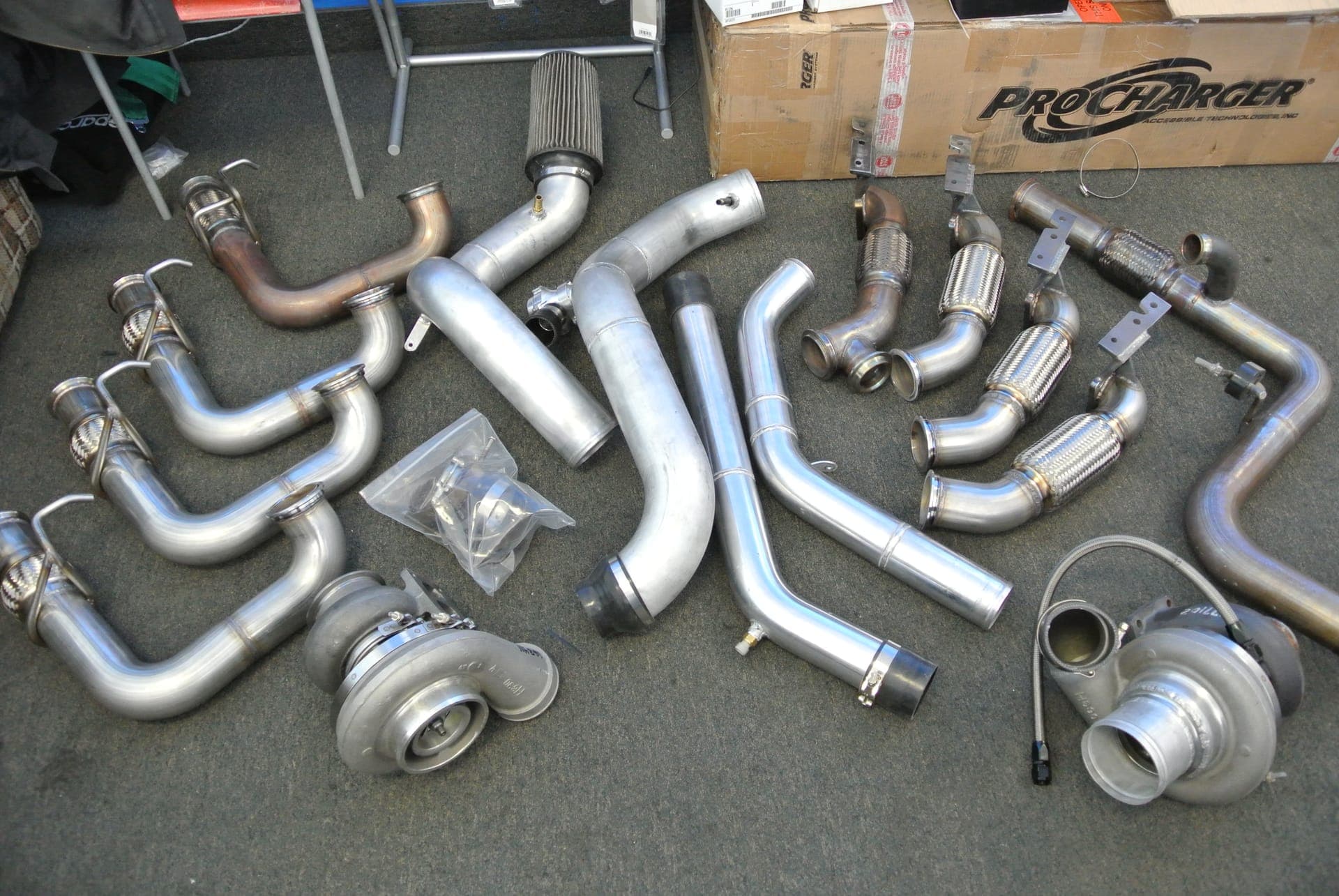 Turbo kit parts laid out at Turbo Lab: turbochargers, downpipes, and intercooler piping