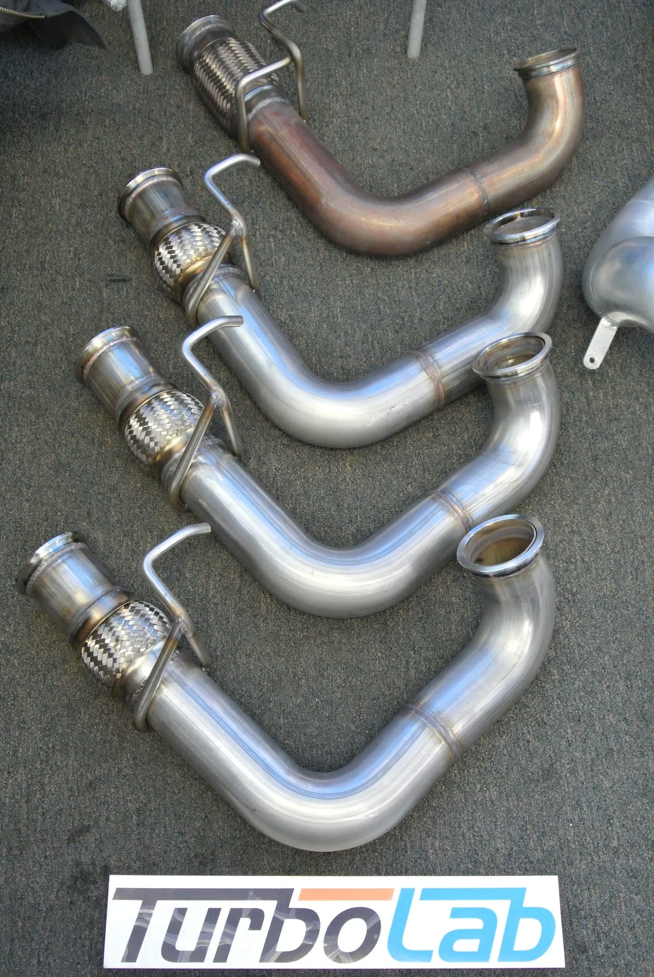 Custom stainless steel turbo downpipes with V-band flanges made at Turbo Lab