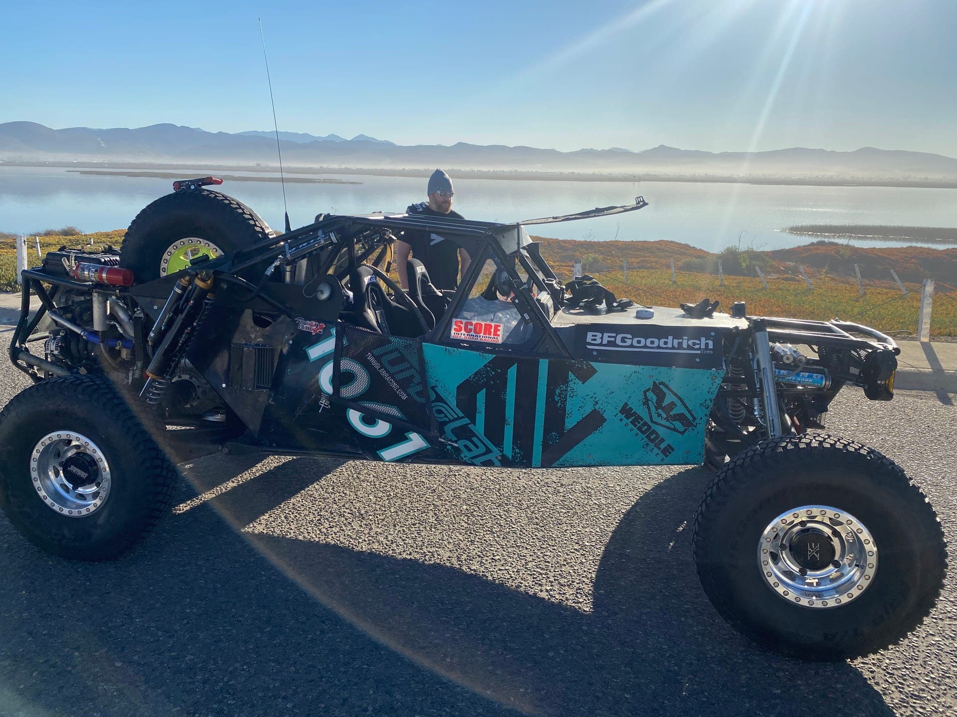 The #1061 desert race buggy built and tuned with Turbo Lab, parked by a Utah lake