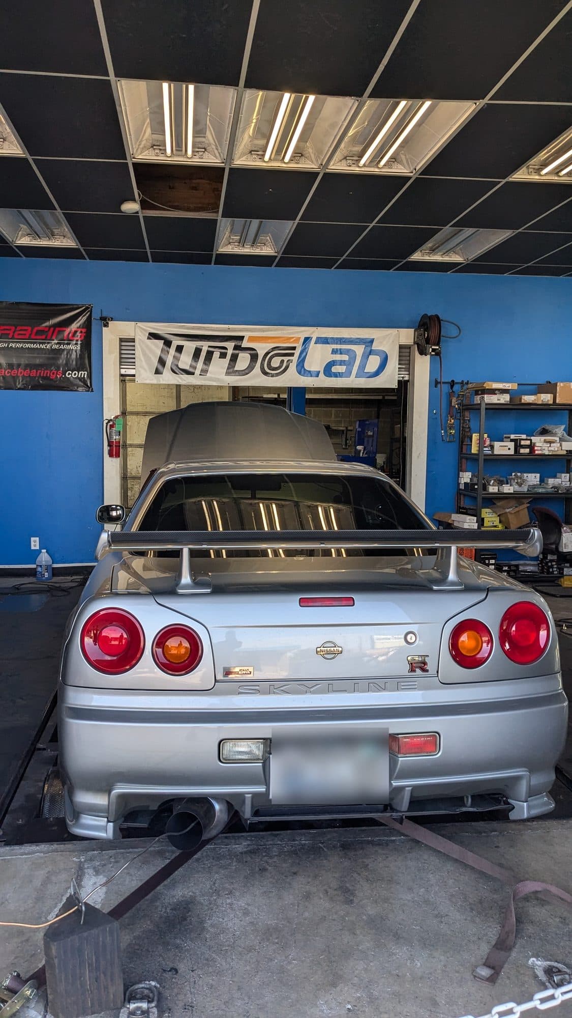 Nissan R34 Skyline GT-R strapped to the AWD Dynojet under the Turbo Lab sign in Orem, UT