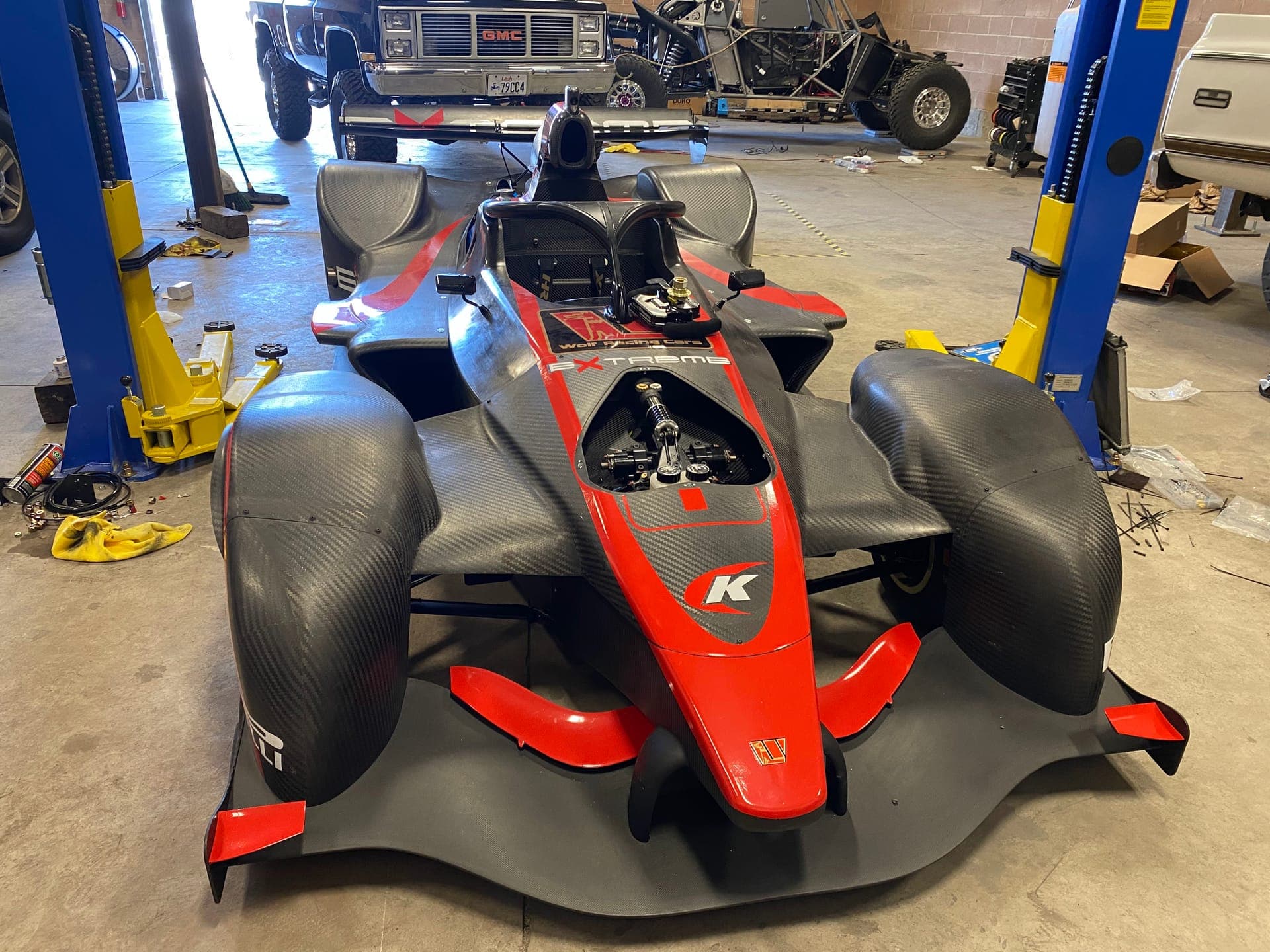 Open-wheel race car on the lifts for race preparation at Turbo Lab in Orem